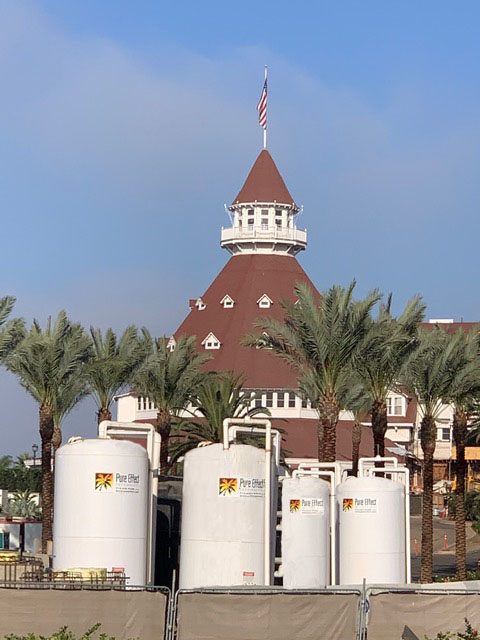 White branded Pure Effect carbon vessels staged in front of the Hotel del Coronado's red-roofed turret and palm trees