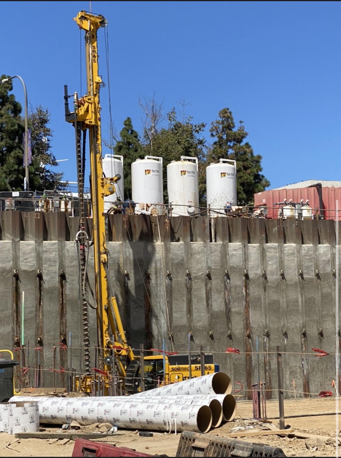 White Pure Effect carbon vessels staged atop a shored excavation wall beside a drilling rig at a construction site