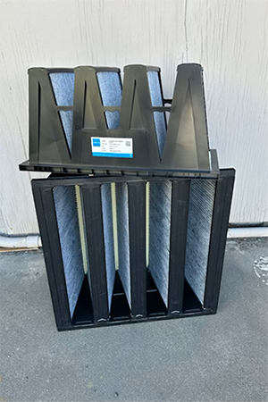 Black Pure Effect multi-pocket bag-filter and carbon filtration unit photographed against a wall